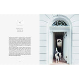 A Resident Dog Volume 2 | Nicole England is standing in the doorway of a white house.