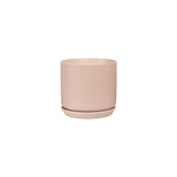 A small pink stoneware Oslo Planter - Peach, by Potted, on a white background.