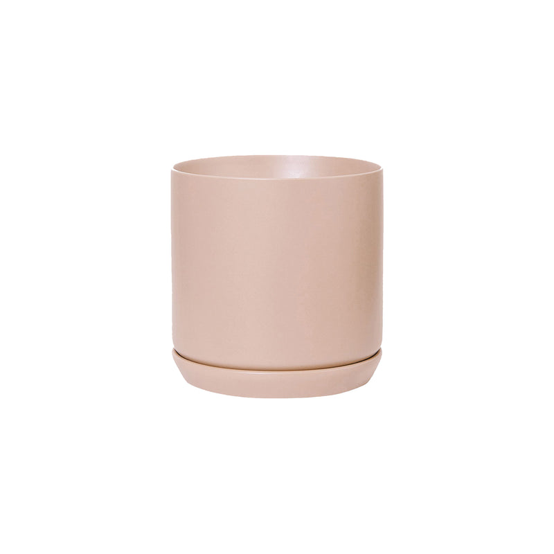 Description: A small pink Oslo Planter - Peach, a stoneware planter by Potted, on a white background.