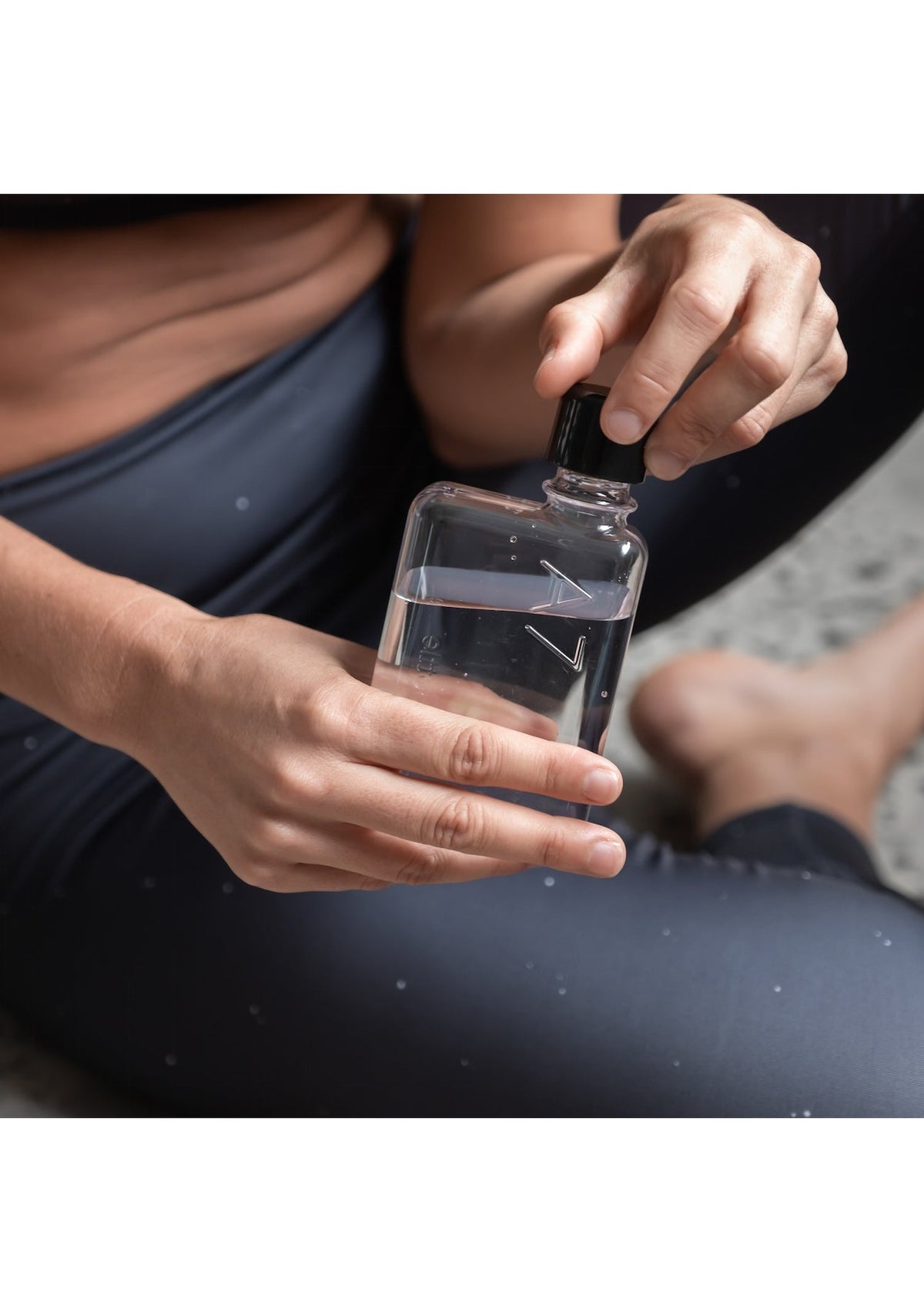 A woman holding a A7 Memobottle by MemoBottle.