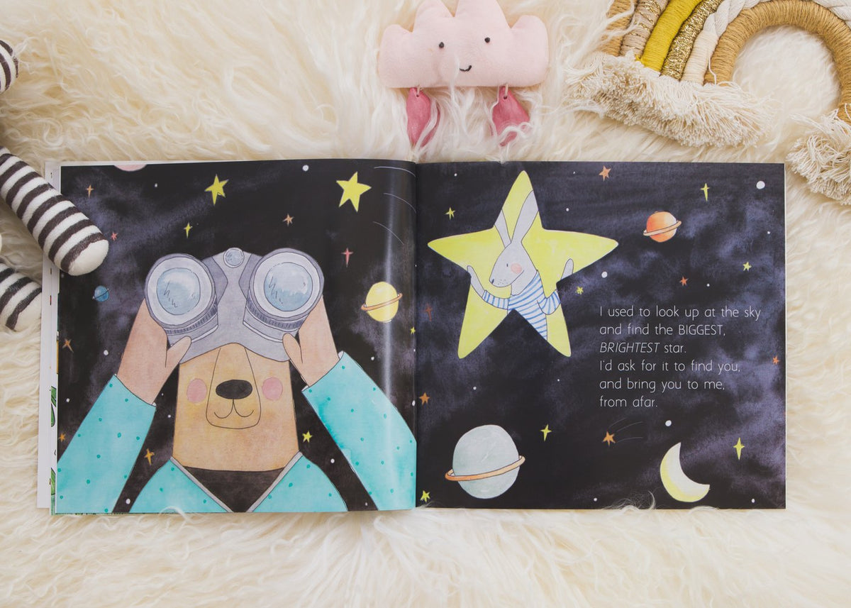 A BEFORE YOU WERE HERE book by Olive + Page featuring a teddy bear amidst stars.