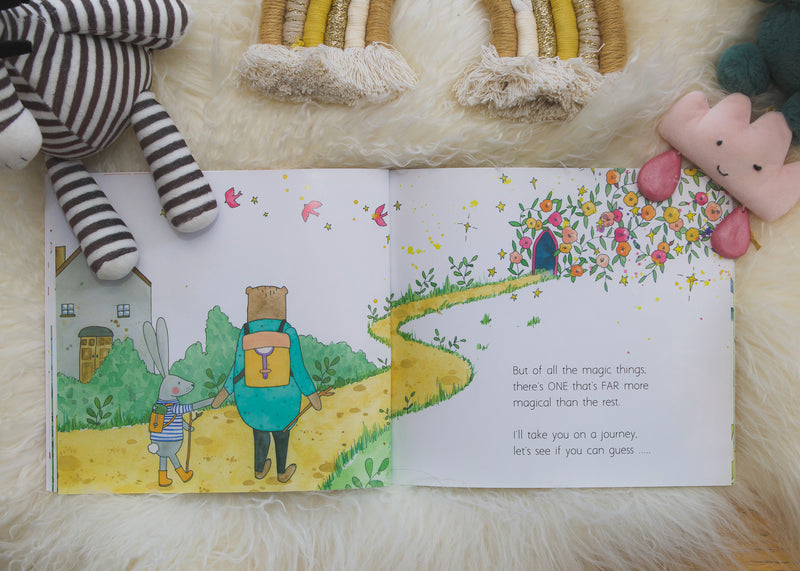 Spread from In a World Full of Magic with a bear on a winding yellow path, among plush toys