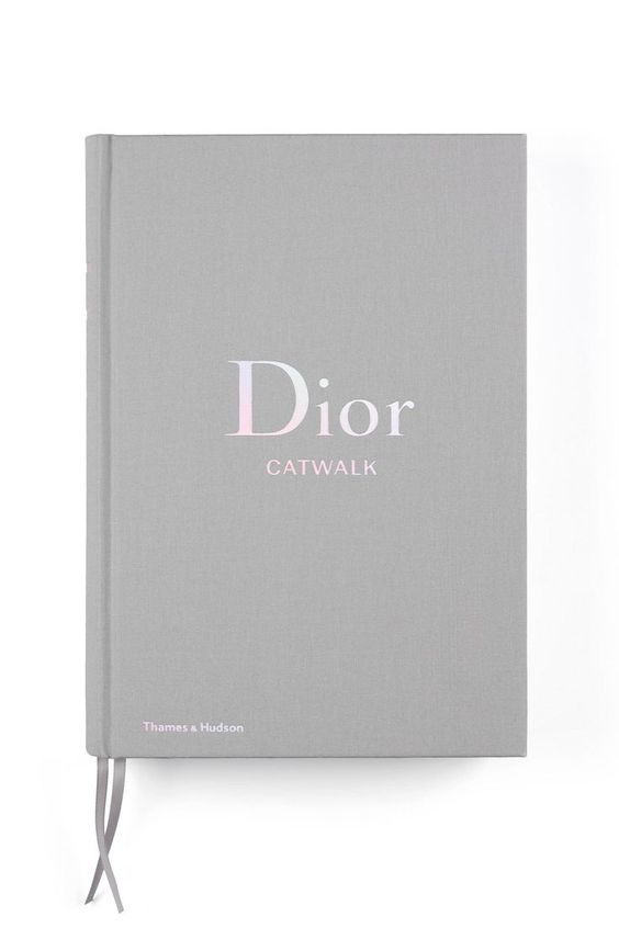 A grey book with the word Dior Catwalk: The Complete Fashion Collections on it.