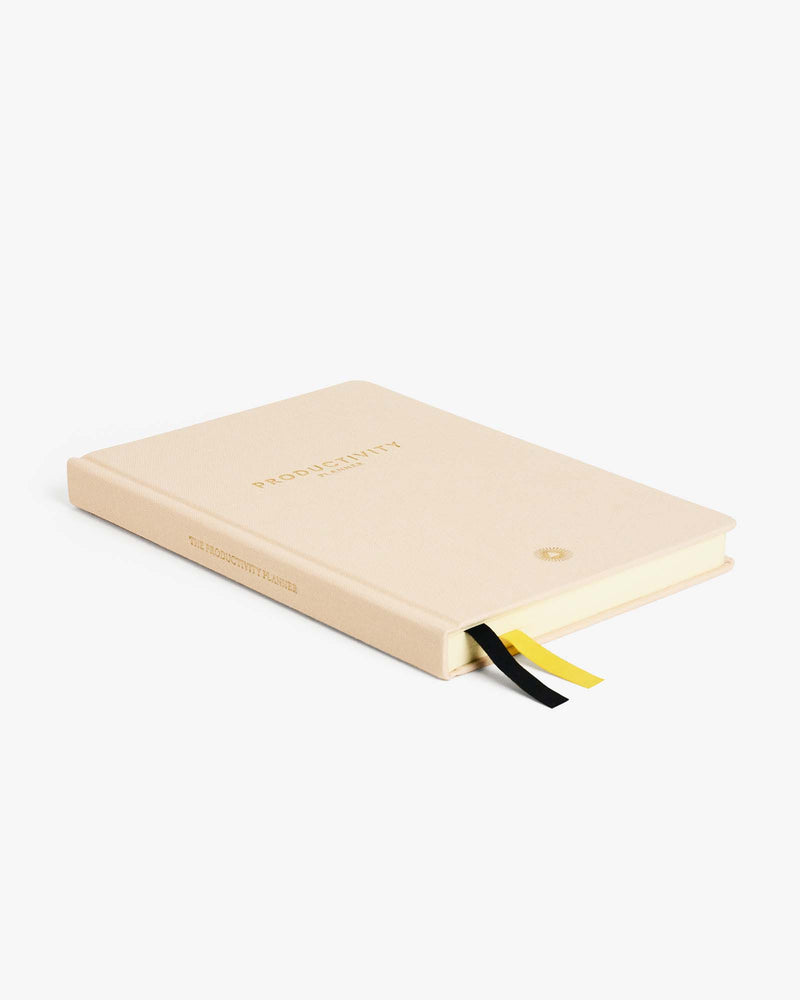 Description: A Intelligent Change productivity planner with a yellow ribbon on a white background.
