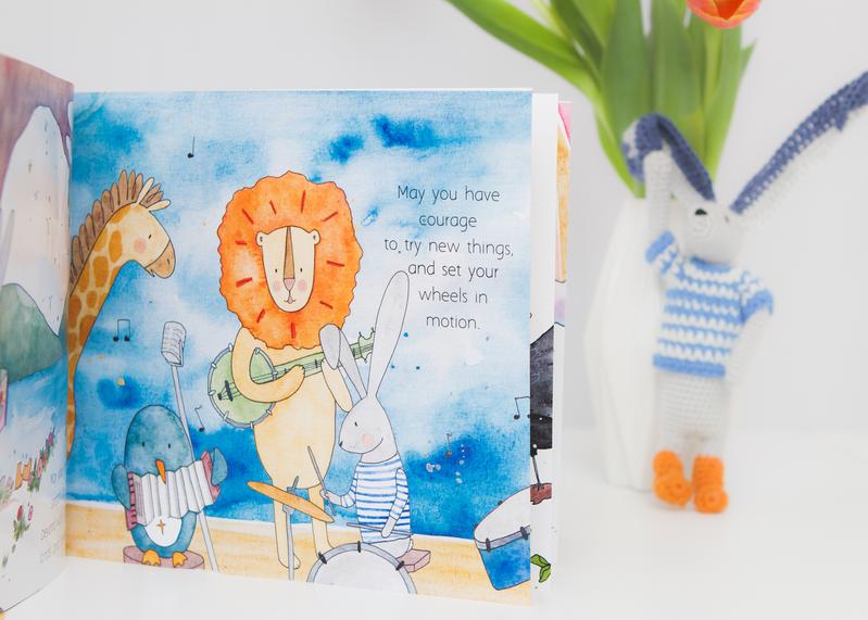 A children's book with a picture of a lion and a teddy bear, called "MY WISHES FOR YOU" by Olive + Page.