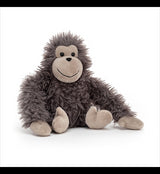A cuddled Jellycat Bonbon Gorilla with grey fur sitting on a white background.