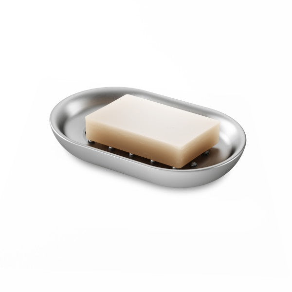 A stylish Junip Oval Soap Dish - Stainless Steel from the Umbra brand, elegantly placed on a pristine white surface.