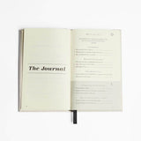 The Intelligent Change journal, based on psychology principles, placed open on a white surface.