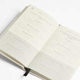 An Intelligent Change journal designed for cultivating gratitude, featuring a black cover and including a black pen.