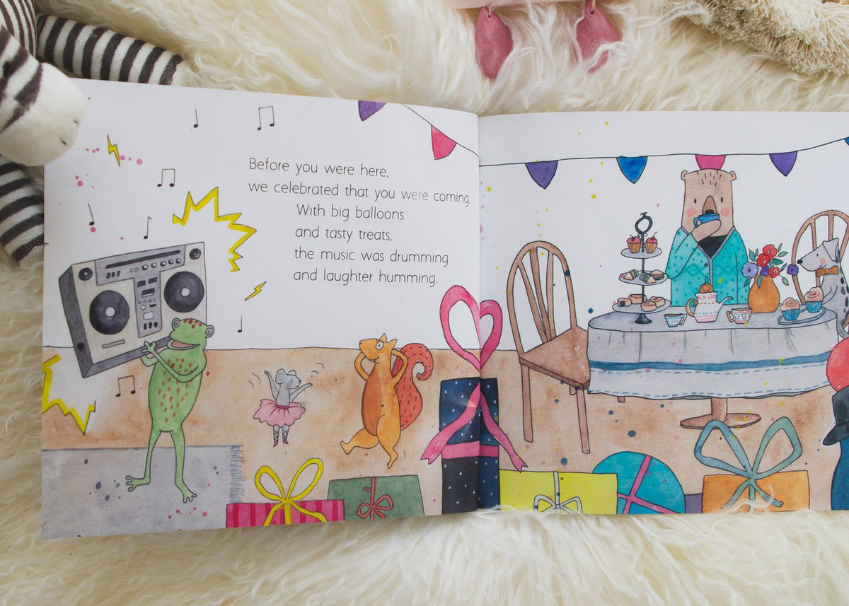 A children's book featuring Olive + Page's "BEFORE YOU WERE HERE" teddy bear.