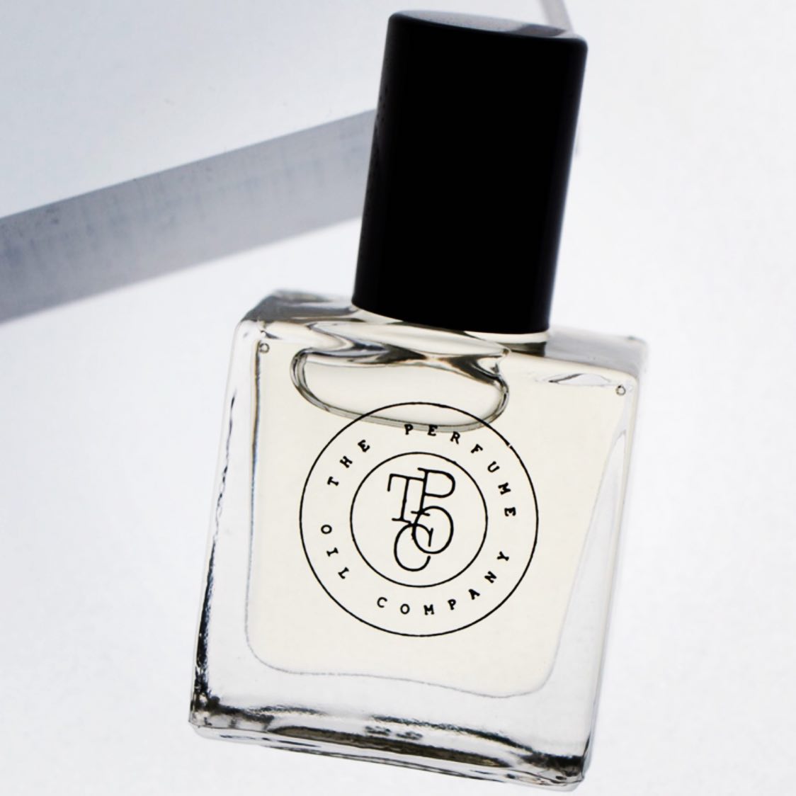 A bottle of NUDE perfume, inspired by Beige (CC), sitting on top of a white box produced by The Perfume Oil Company.