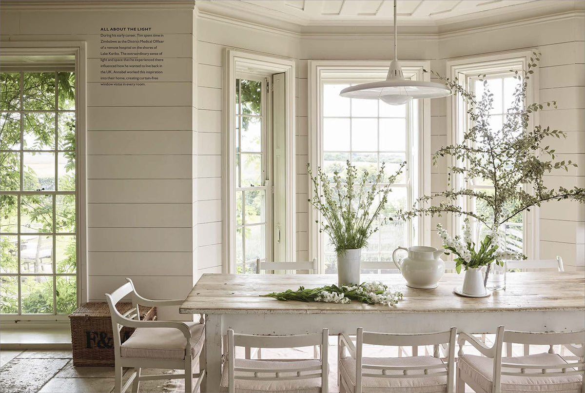 The Art of Living With White page spread showing a dining space