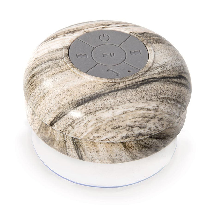 An Albi wireless shower speaker with assorted natural prints on a white surface.