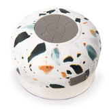 An Albi Wireless Shower Speaker - Assorted Natural Prints on a white surface.