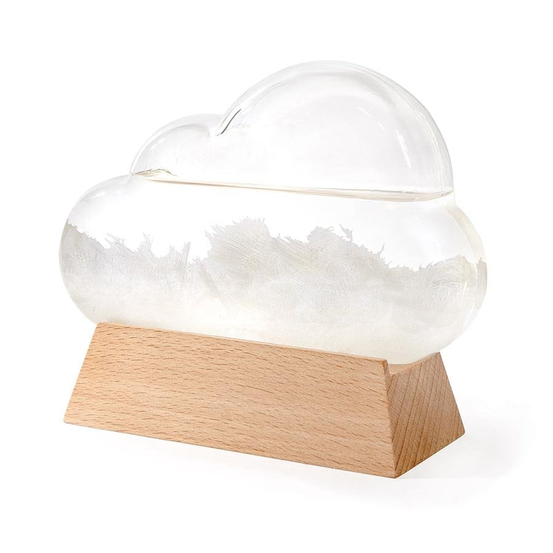 An Albi Cloud Weather Station displayed in a cloud shaped glass container on a wooden base.