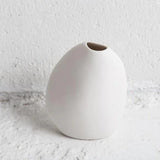 A Great Harmie Vase - White / Natural sitting on top of a white wall, artfully crafted by Vietnamese Artisans and part of the Ned Collections.