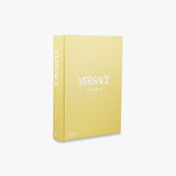 A yellow book with the word Versace on it. product: "Catwalk: The Complete Fashion Collections - Various Options" brand: Books