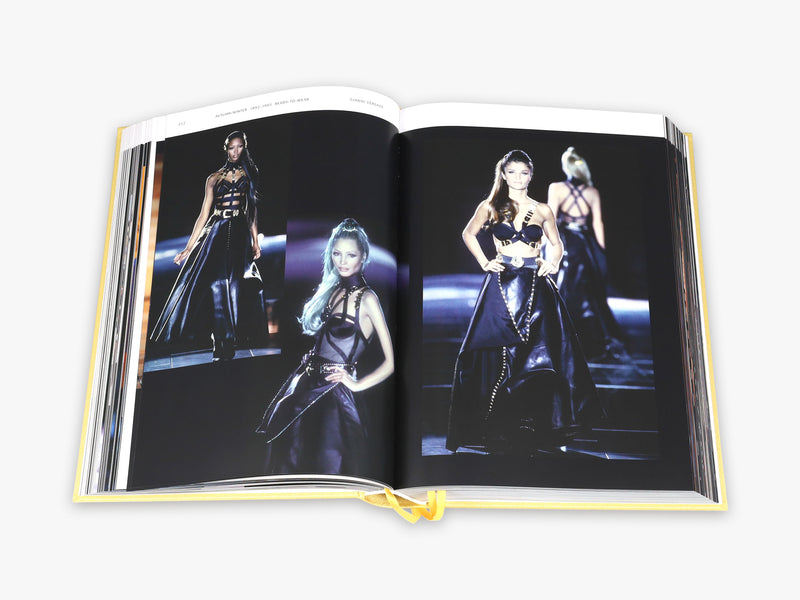 An open book with pictures of women in black dresses, Catwalk: The Complete Fashion Collections - Various Options by Books.