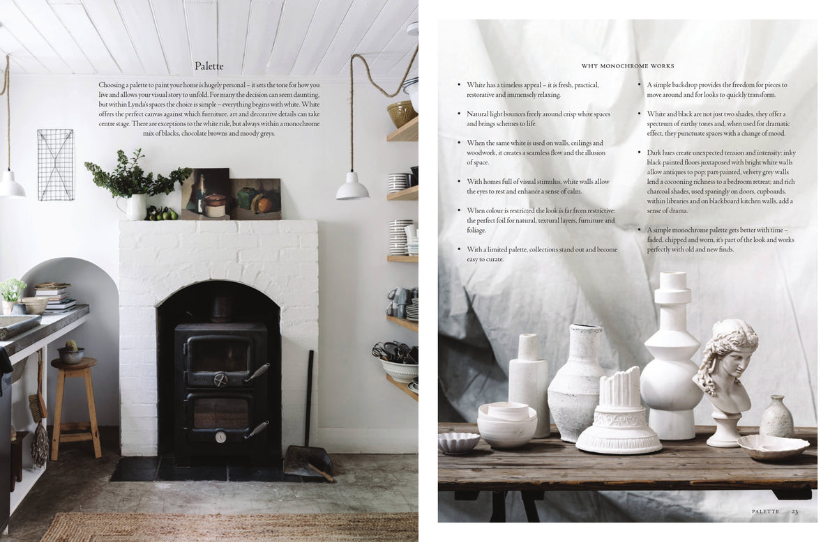 Curate spread showing a white room with a black wood burner beside a page of white ceramics