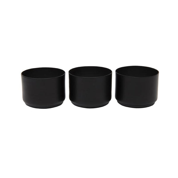 Three Zakkia black tealight candle holders on a white background.
