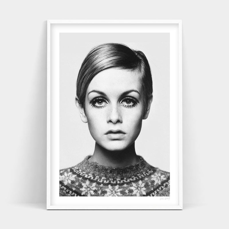 A black and white photo of a woman in a sweater, available for delivery as TWIGGY Art Prints.