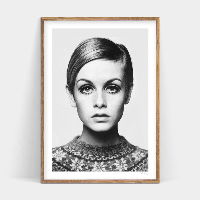 A TWIGGY black and white photo of a woman in a sweater available for Art Prints delivery.