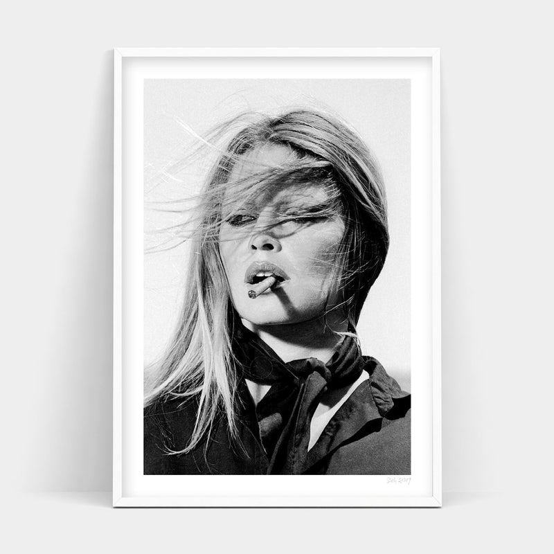 A black and white photo of a woman smoking a cigarette, available for BARDOT prints by Art Prints.