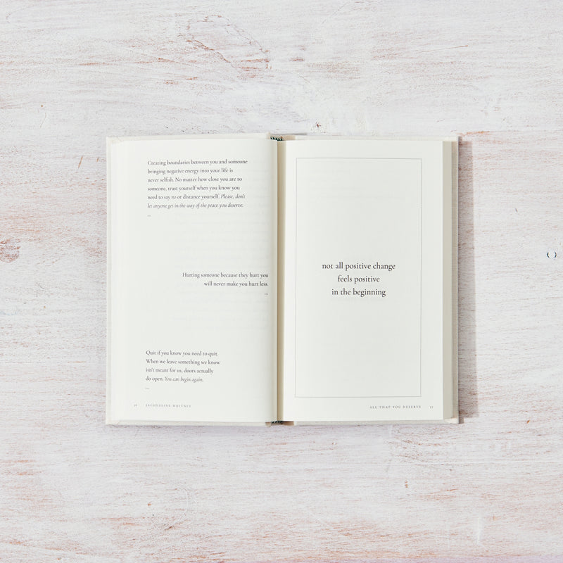 An open book with a quote on it, designed for those seeking inspiration and healing through lifestyle books called "All That You Deserve" by Jacqueline Whitney, published by Thought Catalog.