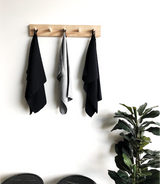 Three grey microfibre tea towels with a lint free finish hanging on a wooden rack from Barkly Basics.