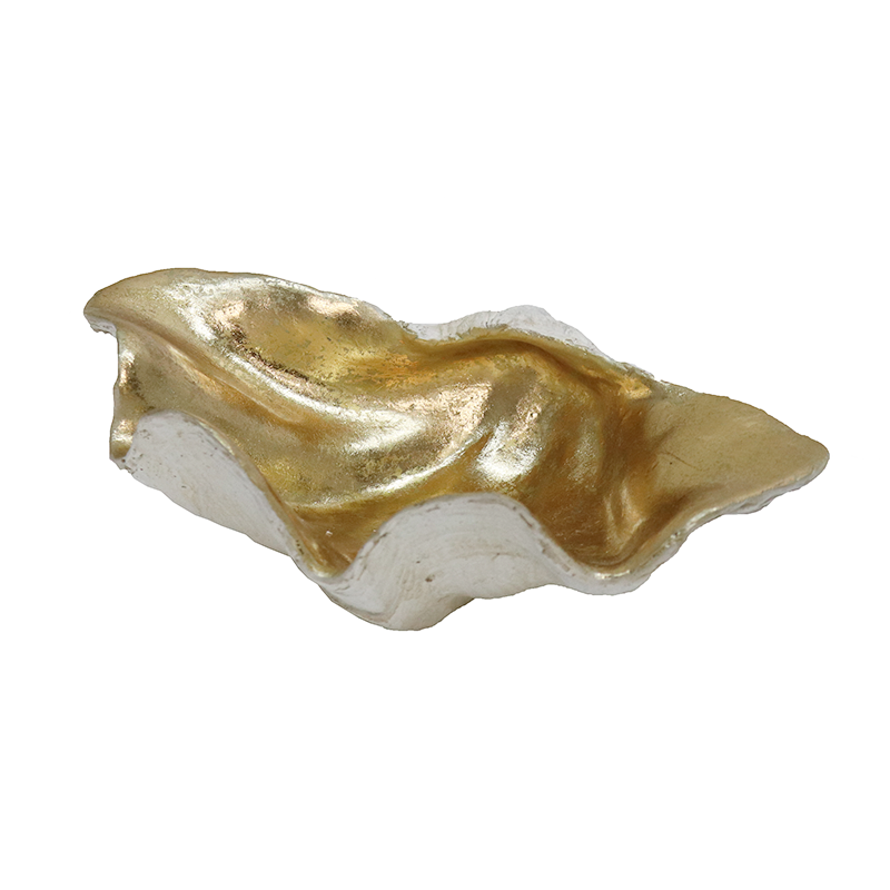 Low side profile of the white and champagne clam shell bowl on white