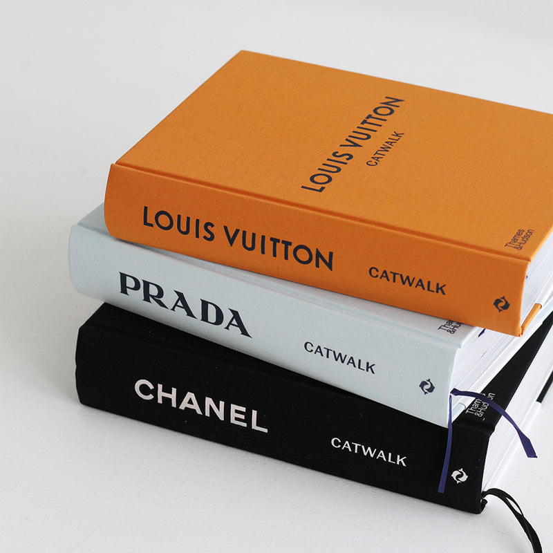 Prada, Louis Vuitton, and Chanel Catwalk: The Complete Fashion Collections - Various Options books stacked on top of each other.