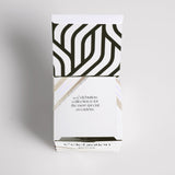A black and white gift box with an Ecoya Celebration | White Musk & Warm Vanilla Mini Candle.