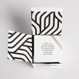 A black and white gift box with an Ecoya Celebration | White Musk & Warm Vanilla Mini Candle quote on it.