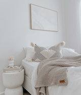 A white bed with COAST CUSHION COVER blanket and Oeko-tex certified pillows from Bengali Collections.