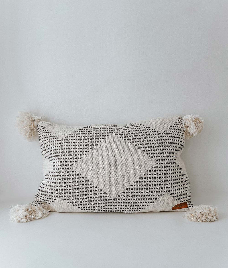 A COAST CUSHION COVER with pom poms, made of pure cotton, from Bengali Collections.
