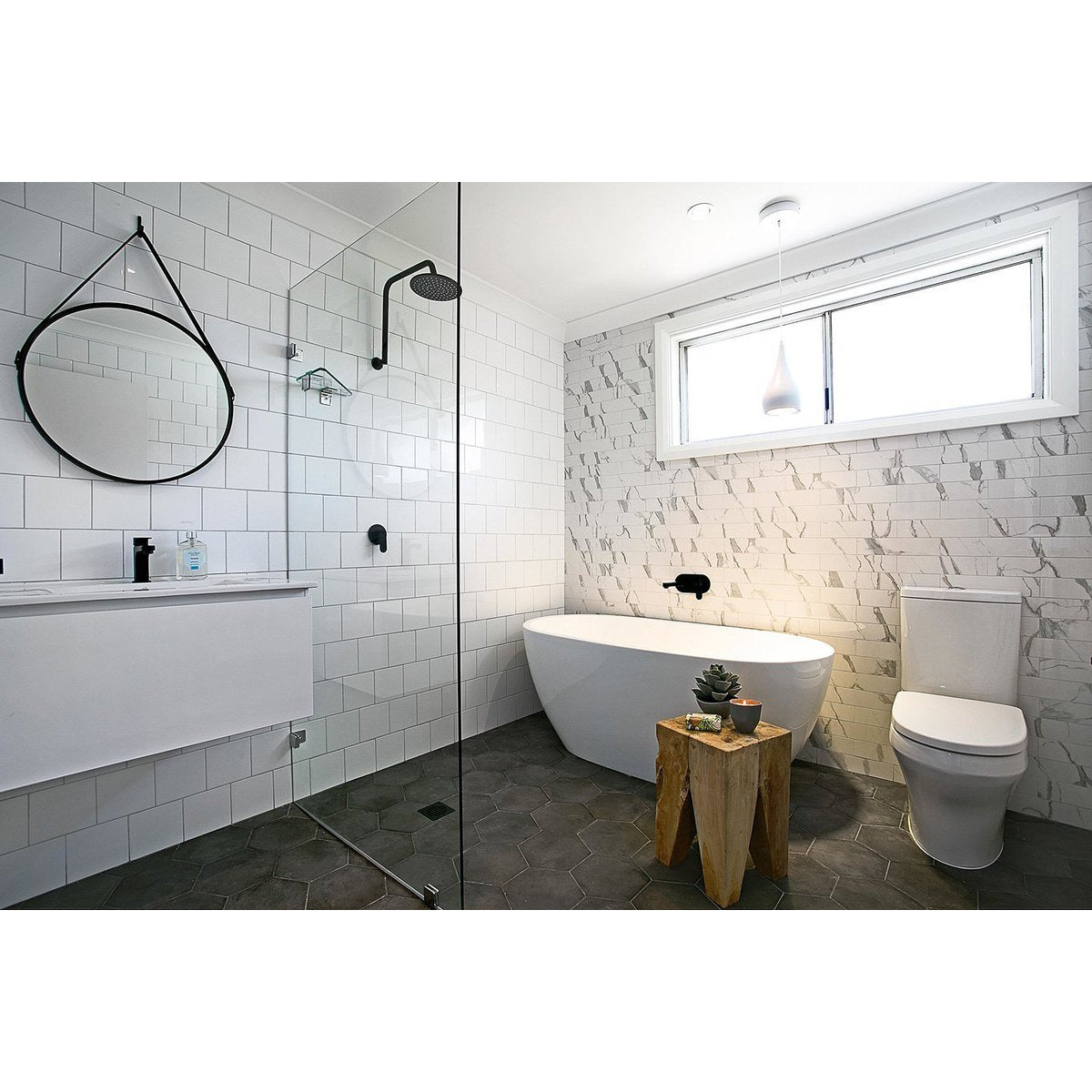 Renovated bathroom with a bathtub featured in Three Birds Renovations