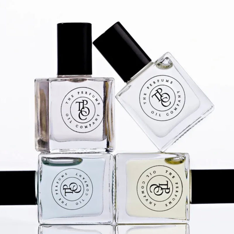 Three bottles of SASS, inspired by Black Opium (YSL) nail polish by The Perfume Oil Company on a white surface.
