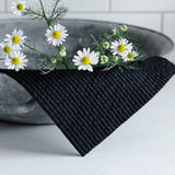 A limited edition Good Change Swedish Dish Cloths - Black (2-PACK) featuring daisies in a bowl.