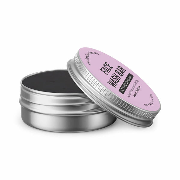 A tin with a black lid and a pink lid, perfect for storing your skincare routine essentials like The Bonbon Factory's ACTIVATED CHARCOAL & FRENCH CLAY | FACE WASH BAR.