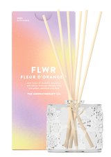 The Aromatherapy Co FLWR Diffuser - Fleur D'Oranger with orange sticks and a box featuring aromatic grapefruit.