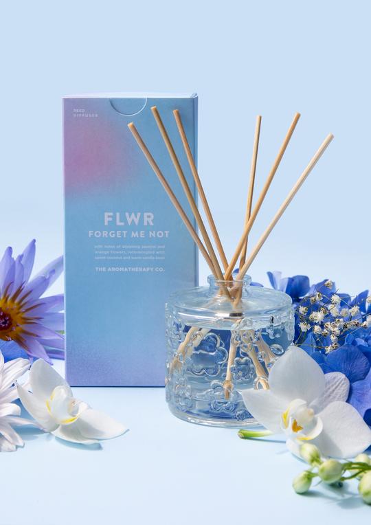The Aromatherapy Co FLWR Diffuser - FORGET ME NOT with blue flowers and a box scented with Jasmine.