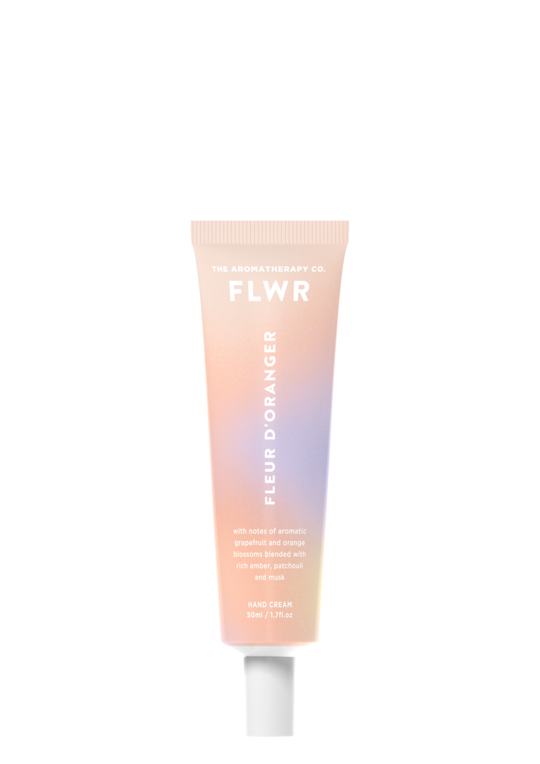 A tube of FLWR Hand Cream - Fleur D'Oranger by The Aromatherapy Co on a black background.