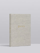 A special occasion GUEST BOOK with gold lettering on it, called GUESTS. GUEST BOOK. GREY by Write To Me.