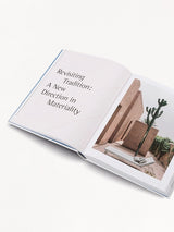A book called "The New Mediterranean" by Gestalten is open with a picture of a plant, showcasing minimalist interior design.