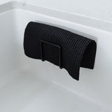 A limited edition Good Change Swedish Dish Cloths - Black (2-PACK) hangs on the side of a sink.
