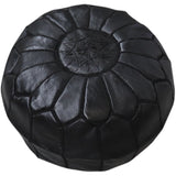 A Moroccan Leather Pouf - Black by Flux Home hand stitched on a white background.