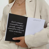 A woman holding a limited edition Planner - Sand from Papier HQ.