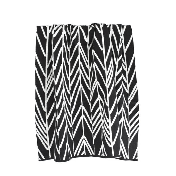 A Featherland Baby Blanket with a chevron pattern made from machine washable cotton yarns from Bengali Collections.