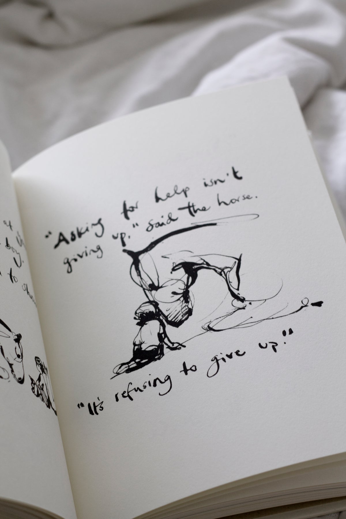 A "Charlie Mackesy | The Boy, The Mole, The Fox and The Horse" book with a drawing of a dog on it.