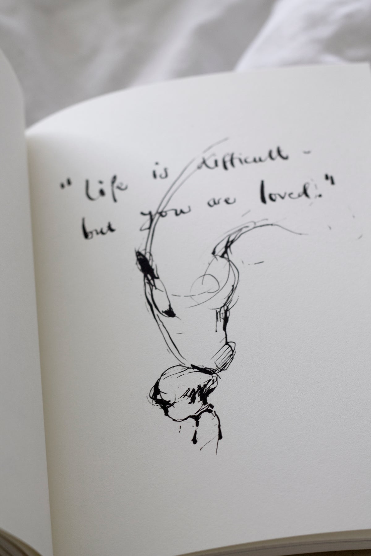 An open Charlie Mackesy | The Boy, The Mole, The Fox and The Horse book.
